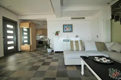 a living room with a couch and a table at Amoutsa Seaside Villa in Kolymvari