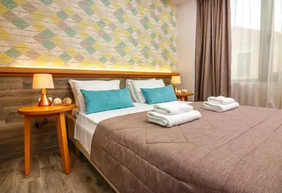 a bedroom with a bed with towels on it at Rigas City Apartment (BLUE) in Chania Town