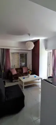 a living room with a couch and a table at Top Holidays Apartments in Chania Town