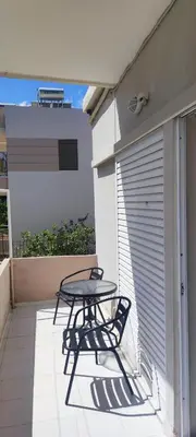 a table and chairs on the balcony of a house at Top Holidays Apartments in Chania Town