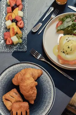 a table with two plates of breakfast food on it at Chania Flair Boutique Hotel, Adults only, Tapestry Collection by Hilton in Chania Town