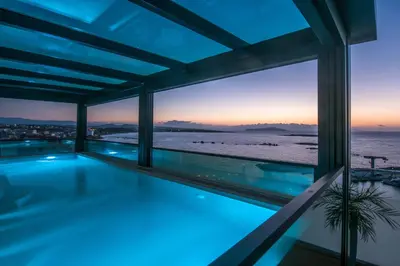 a swimming pool in a house with a view of the ocean at Chania Flair Boutique Hotel, Adults only, Tapestry Collection by Hilton in Chania Town