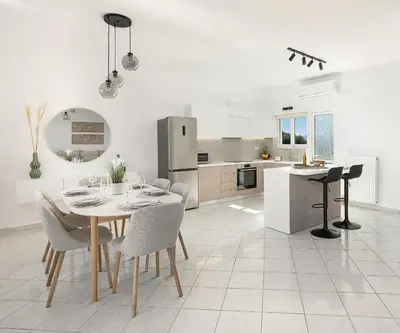 a kitchen and dining room with a table and chairs at Villa Kelaidis in Megála Khoráfia