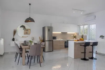 a kitchen and dining room with a table and a refrigerator at Villa Kelaidis in Megála Khoráfia