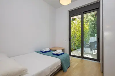 a bedroom with a bed and a sliding glass door at Villa Darazzo with Private Pool in Daratso
