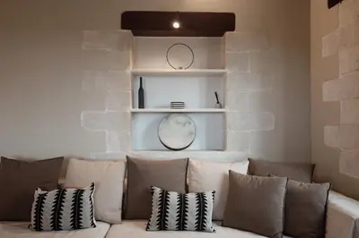 a living room with a couch with pillows at Prinus Country Retreat Apokoronas, heated pool, 13km from the sea in Embrósneros