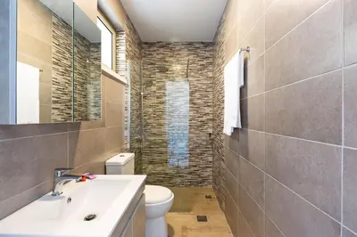 a bathroom with a white sink and a toilet at Blue Horizon Luxury Villas in Falasarna