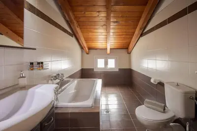 a bathroom with a tub and a toilet and a sink at Villa Konstantinos Hilltop Vineyard Escape in Chania Town