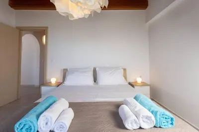 a bedroom with a bed with towels on it at Villa Konstantinos Hilltop Vineyard Escape in Chania Town