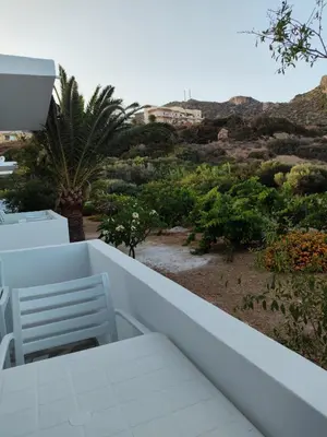 a balcony with a chair and a view of the desert at Protopapas in Palaiochóra