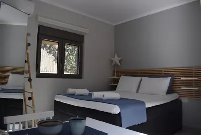 a bedroom with a large bed and a window at Antigonis Garden House in Chania Town