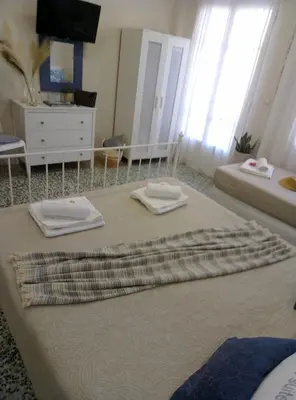 a bedroom with a bed with two towels on it at Marinos Suites in Chania Town