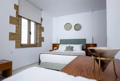 a bedroom with a bed and a sink at Agarathos Deluxe Homes In the Heart of Kaliviani Near Balos in Kissamos