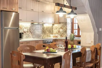 a kitchen with a table and a refrigerator at Cretan Lux Villa Heated Pool in Gavalochori