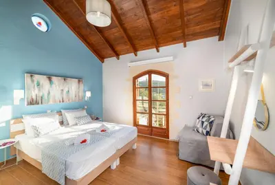 a bedroom with a large bed and a couch at Cretan Lux Villa Heated Pool in Gavalochori