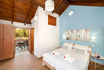 a bedroom with a bed and a dining room at Cretan Lux Villa Heated Pool in Gavalochori
