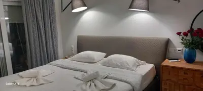 a bedroom with a bed with white sheets and pillows at GIANNIS in Galatás