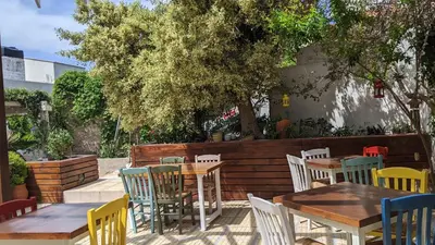 a group of tables and chairs in a patio at Pension Irene in Sougia
