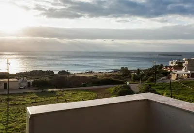 a view of the ocean from the balcony of a house at Aqua Marine in Falasarna