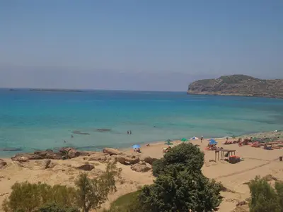 a group of people on a beach with the ocean at Aqua Marine in Falasarna
