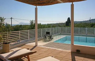 a house with a swimming pool with a bike next to it at Villa Bamboo in Maleme