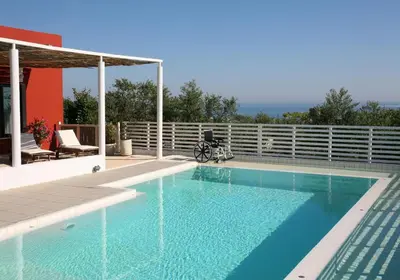 a swimming pool with blue water in a house at Villa Bamboo in Maleme