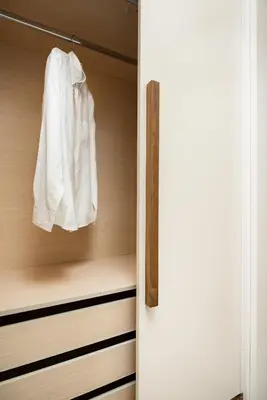 a closet with a white shirt hanging in it at Amaré Chania Luxury Residence in Stérnai
