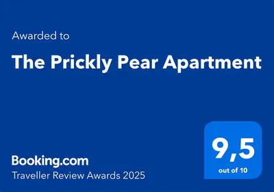 a blue sign that reads the prickly pear apartment at The Prickly Pear Apartment in Chania Town