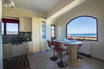 a kitchen with a table and a view of the ocean at Terpsis House in Kissamos