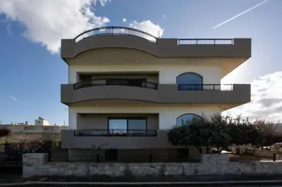 a building with balconies on the side of it at Terpsis House in Kissamos
