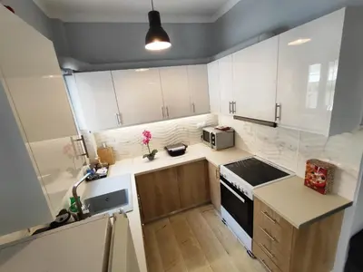 a small kitchen with white cabinets and a sink at Marlen House Chania in Chania Town