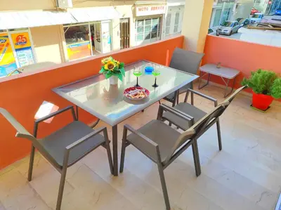a table with two chairs and a plate of flowers on it at Marlen House Chania in Chania Town