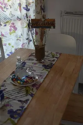 a wooden table with a plate and a vase on it at Captain Nick in Chania Town