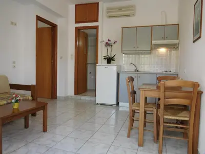 a kitchen and dining room with a table and a refrigerator at Anthea Apartments in Palaiochóra