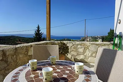 a table with coffee cups sitting on top of it at Kukuwaia in Almirida