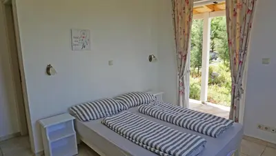 two pillows on a bed in a room with a window at Kukuwaia in Almirida