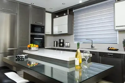 a kitchen with a counter with two wine glasses at Larimar Luxury Sea View Villa in Kissamos