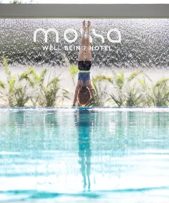 a person in the water in a swimming pool at Mossa Well Being Hotel - Heated pool and Wellness Spa in Kato Daratso