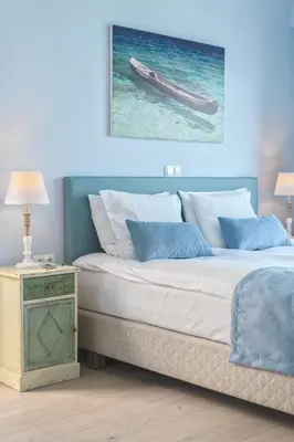 a bedroom with a bed with a picture on the wall at Celestine Suites in Kolymvari