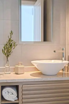 a bathroom with a white sink and a mirror at Celestine Suites in Kolymvari