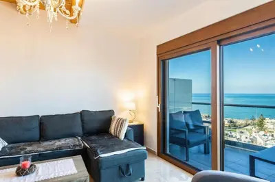 a living room with a couch and a view of the ocean at Platania's Horizon in Plataniás