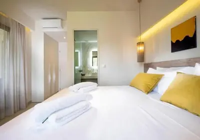 a large white bed with two white towels on it at Southern Paradise Villas - Private Pool in Kalamaki Chanion