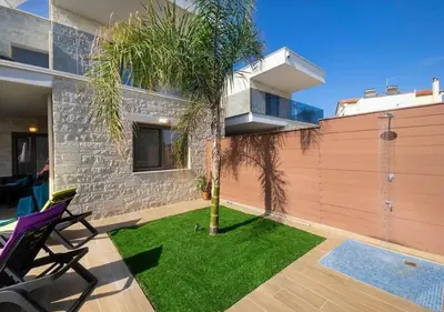 a palm tree in a yard next to a house at Southern Paradise Villas - Private Pool in Kalamaki Chanion