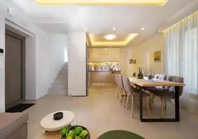 a dining room and kitchen with a table and chairs at Southern Paradise Villas - Private Pool in Kalamaki Chanion