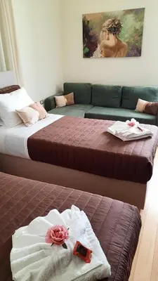 a hotel room with two beds and a couch at Creta Galini House in Sirílion