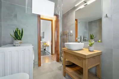 a bathroom with a white sink and a mirror at Sea City and Mountain View Apartment in Chania Town