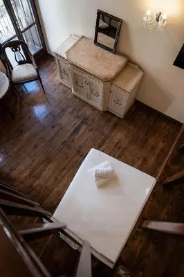 a room with a table and chairs and a desk at Old Town Suites in Chania Town