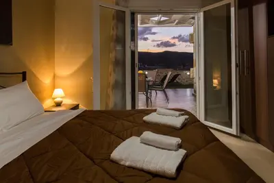 a bedroom with a bed with two towels on it at Castello Villa - Seaview Villa atop the Venetian Walls in Kissamos