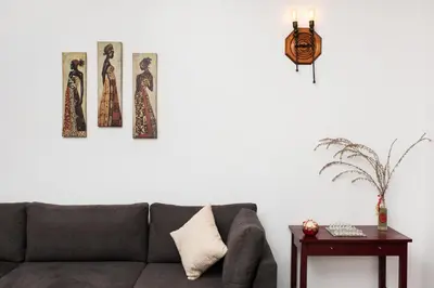 a living room with a couch and three pictures on the wall at Vista del Puerto in Chania Town