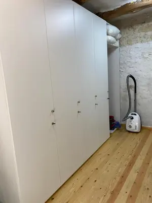 a row of white cabinets in a room with a wooden floor at Old stone villa in Apokoronas Villa Nostalgia Kreta in Fílippos